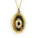 A boxed yellow metal (tested minimum 9ct gold) sapphire and diamond set locket pendant and chain, L.