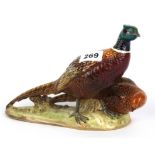 A Beswick porcelain figure of wild pheasants, size 18 x 26cm.