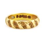 An 18ct yellow gold patterned ring, (M).