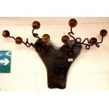 An unusual ironwork hat rack finished with turned wooden balls, W. 87cm.