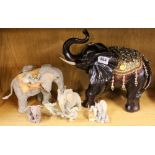 Four Tuskers elephant figures and a further elephant figure.