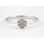 A 9ct white gold diamond set cluster ring, (Q).