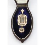 A mid 19th century yellow metal (tested 18ct gold) mourning pendant set with seed pearls and an