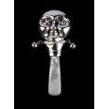 A sterling silver and mother of pearl man in the moon baby rattle, L. 8cm.