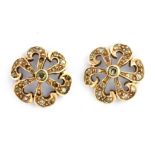 A pair of yellow metal (tested 9ct gold) diamond set flower shaped earrings, Dia. 1.5cm.