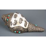 A Tibetan white metal decorated conch trumpet, L. 25cm.