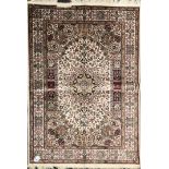 A finely woven cream ground rug, size 200 x 130cm.