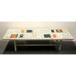 A 1960's tile topped wooden coffee table, 154 x 51 x 39cm.