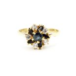 A 14ct yellow gold (stamped 585) sapphire and white stone set cluster ring, (P.5).