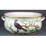 An 18th century gilt and hand painted porcelain foot bath with decoration of a bird amongst foliage,