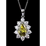 A boxed 950 platinum pendant and chain set with a 3.02ct fancy deep greenish yellow pear cut diamond