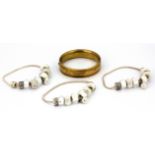 A gold plated bangle and three silver charm bracelets, Dia. 6cm.