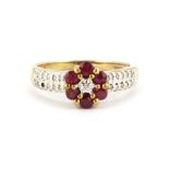 A 9ct yellow gold ruby and diamond set cluster ring with diamond set shoulders, (one small diamond