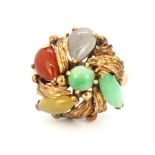 An 14ct yellow gold (stamped 14k) ring set with jade, cornelian and other semi-precious stones, (
