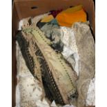 A box of mixed Indian fabrics, cushion covers etc.