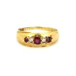 An 18ct yellow gold (worn hallmark) ruby and diamond set ring, (L).