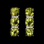 A pair of 925 silver earrings set with three cushion cut peridots and white stones, L. 2cm.