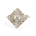 A white metal (tested 18ct gold) diamond set cluster ring, set with an 0.33ct old cut centre