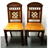 A pair of 19th century mahogany tile backed hall chairs.