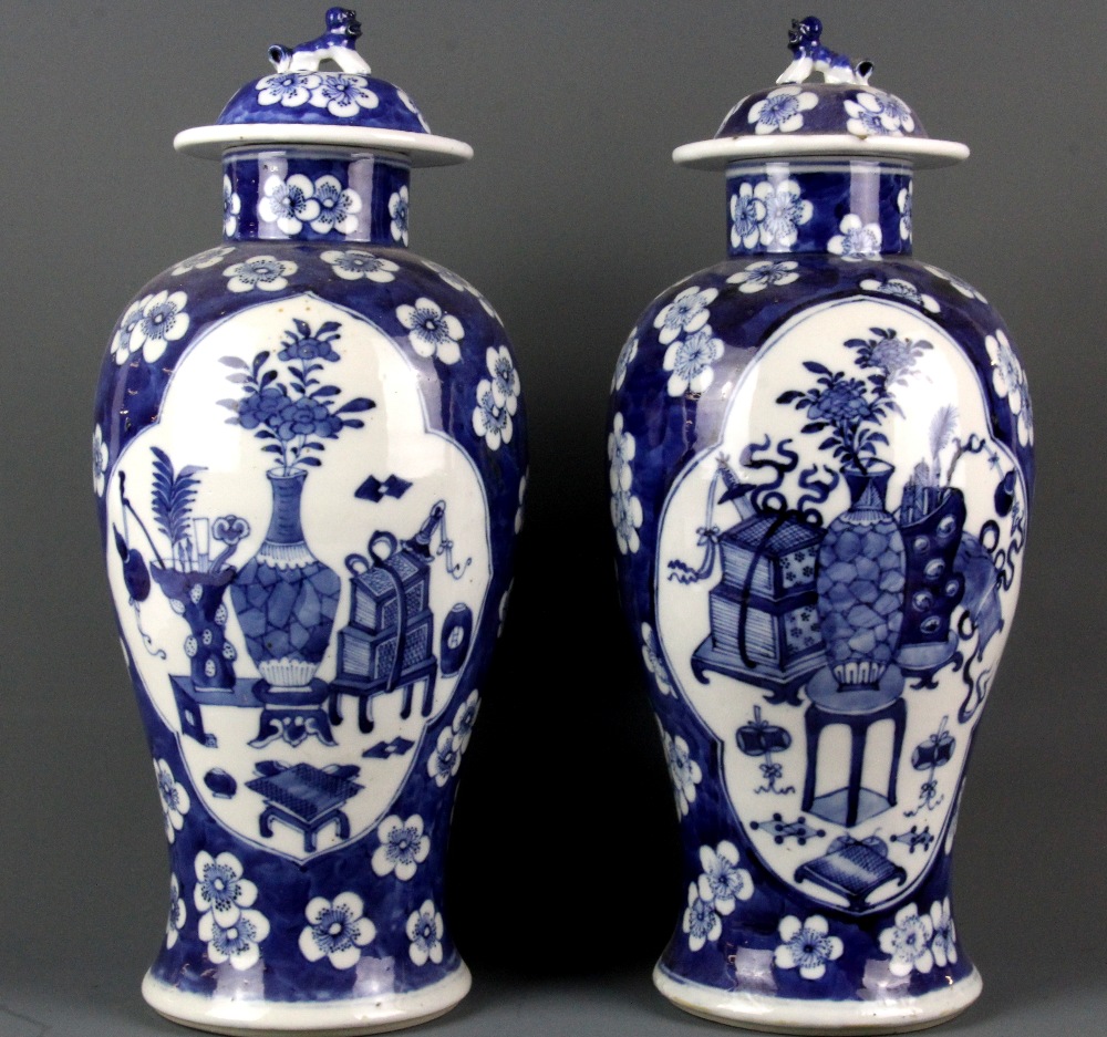 A pair of 19th Century Chinese hand painted porcelain vases and covers, H. 36cm.