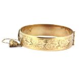 A 9ct yellow gold metal core bangle, L. 6cm.