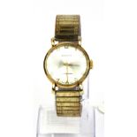 A gent's vintage 9ct gold Garrard wrist watch on an expanding gold plated strap.