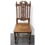 A Victorian carved oak hall chair.