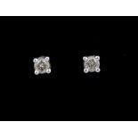 A pair of 18ct white gold (stamped 750) diamond set stud earrings, approx. 0.20ct.