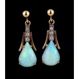 A pair of yellow and white metal (tested 9ct gold) drop earrings set with cabochon cut opals and