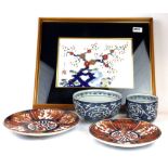 A framed Japanese hand painted porcelain panel, 48 x 38cm, with two Imari plates and two bowls.