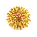 An 18ct yellow gold ruby set brooch, Dia. 3.2cm.