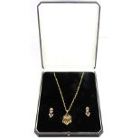 A boxed suite of 18ct yellow gold (stamped 750) earrings and matching necklace set with cabochon cut