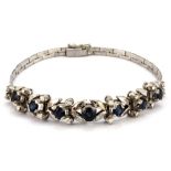 A white metal (tested 18ct) bracelet set with sapphires and diamonds, L. 18cm.