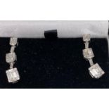 A pair of 18ct white gold drop earrings set with baguette cut diamonds, approx. 1.20ct overall, L.