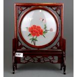 A Chinese embroidered silk, mounted in a revolving redwood frame, H. 35cm.