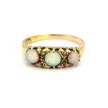 An 18ct yellow gold (worn hallmark) ring set with three cabochon cut opals and rose cut diamonds, (