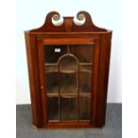 A Georgian mahogany corner wall cabinet, H. 107cm.