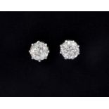 A pair of white metal (tested 18ct gold) stud earrings set with old cut diamonds, approx. 1ct