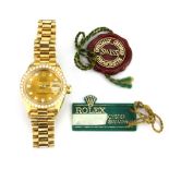 A boxed 18ct yellow gold Rolex Oyster Perpetual lady's wrist watch with original diamond set bezel