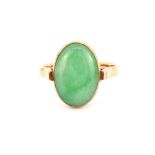 An 18ct yellow gold (stamped 18k) ring set with cabochon cut nephrite jade, (P).