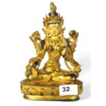 A Tibetan gilt and hand painted bronze figure of a seated Tara, H. 21cm.