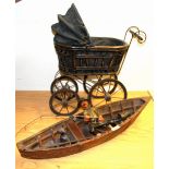 A resin model of a fisherman in a boat and a toy pram, boat L. 74cm pram H. 58cm.