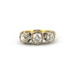 A boxed 18ct yellow and white gold ring set with three old cut diamonds, approx. 1.2ct overall, (O.