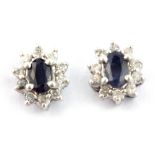 A pair of 18ct white gold (stamped 750) sapphire and diamond set cluster earrings, L. 0.9cm.