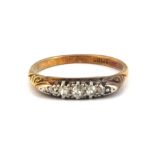 An 18ct yellow gold (stamped 18ct) ring set with five graduated old cut diamonds, (M).