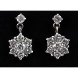 A boxed pair of 18ct white gold diamond set cluster drop earrings, L. 5.5cm.