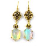 A pair of yellow metal (tested 18ct gold) drop earrings set with cabochon cut opals and rose cut