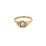 An 18ct yellow gold and platinum (stamped 18ct & plat) diamond set solitaire ring, (J).