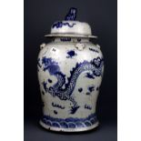 A large 19th Century Chinese Provincial porcelain storage jar and cover decorated with dragons, H.