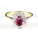 An 18ct yellow gold padparadscha sapphire and diamond set cluster ring, (O.5).
